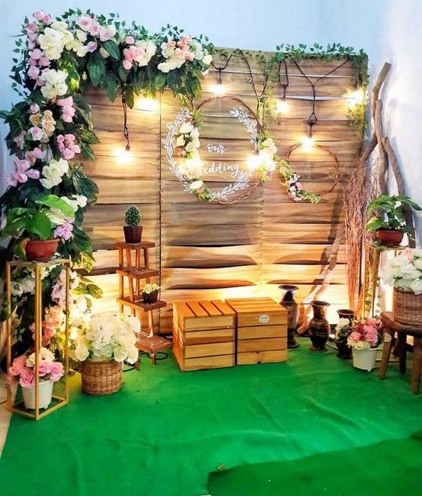 a room filled with lots of flowers and wooden crates on the floor next to a wall