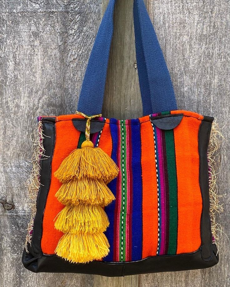 "Brightly coloured tote, two straps ,with leather base & leather & fringe  detail. Ethnic tassel , lined. One large inside  pocket  & another large divided pocket. Snap closure. Upcycled materials. Overall bag dimensions, 14\"wide by 11\", strap measures 11 &1/2\" to shoulder." Rectangular Fringe Shoulder Bag For Daily Use, Fringe Rectangular Shoulder Bag For Daily Use, Top Handle Shoulder Bag With Tassels For Everyday Use, Rectangular Fringe Shoulder Bag For Travel, Rectangular Travel Satchel With Tassels, Daily Use Double Handle Shoulder Bag With Tassels, Rectangular Hobo Bag With Tassels For Shopping, Daily Use Double Handle Bags With Tassels, Rectangular Fringe Shoulder Bag For Everyday Use