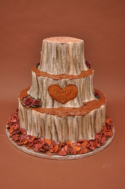 a three tiered cake with hearts carved into it