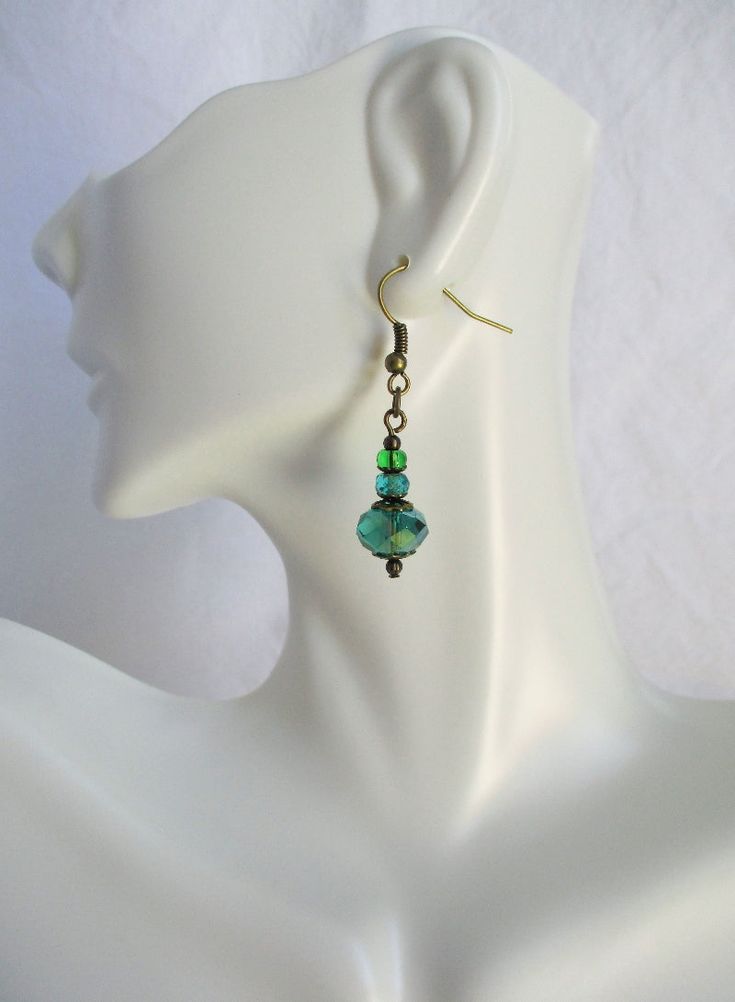 These charming faceted green beaded earrings add a shiny finish to any spring outfit! 1.5" in length, made with glass beads and brass earhooks. These luminous green beaded earrings ship to you in a gift box, ready to give as a present or to keep and store. Back To Beaded Earrings Green Beaded Earrings, Earrings Beaded, Colorful Jewelry, Beaded Accessories, Bead Caps, Green Bead, Earrings Handmade, Spring Outfit, Beaded Earrings