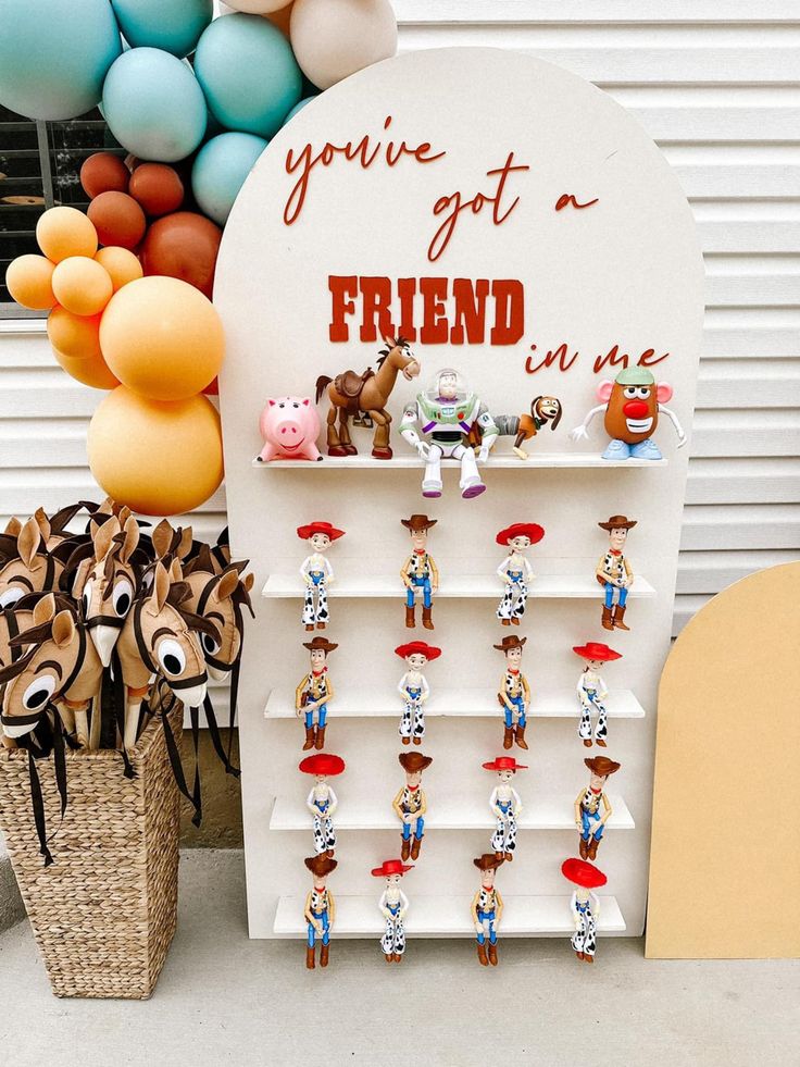 there is a sign that says you've got a friend on it and many toy figurines in front of it