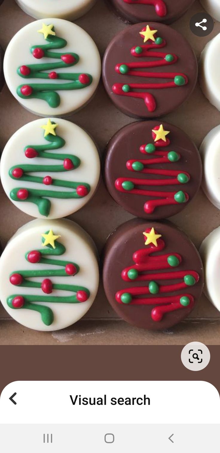 a box filled with lots of decorated cupcakes