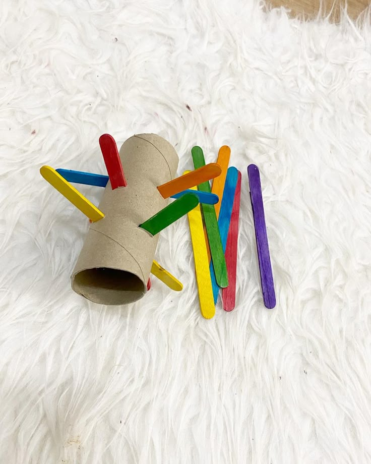 a bunch of colored toothbrushes laying on top of a white fur covered floor