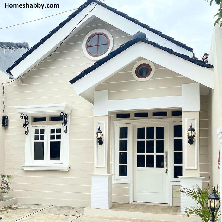 a small house with white trim and windows on the front door is shown in this image