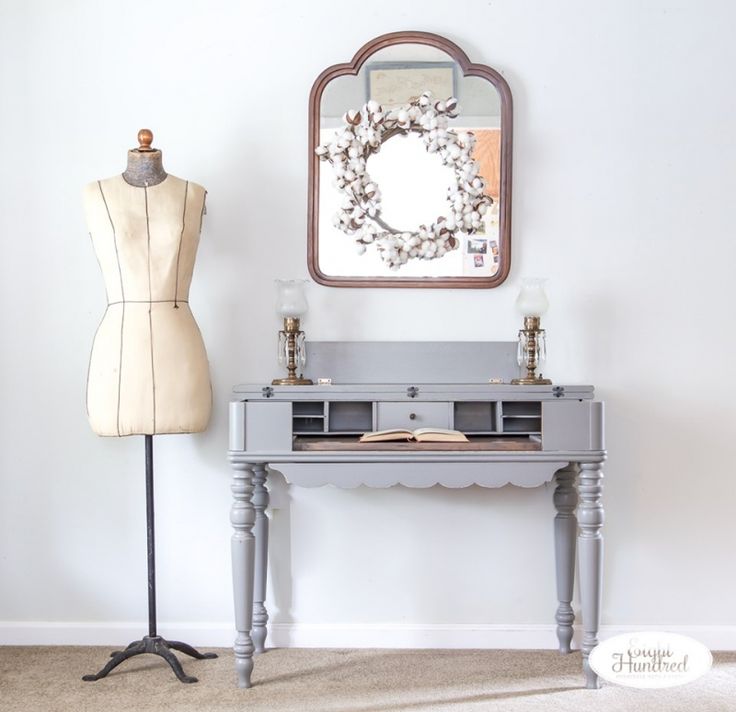 a mannequin is next to a dress form and mirror