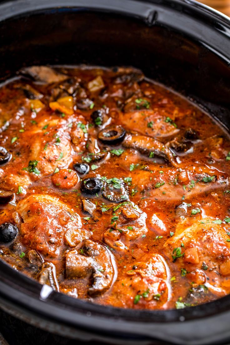 slow cooker chicken cacciatore in a black crock pot with text overlay