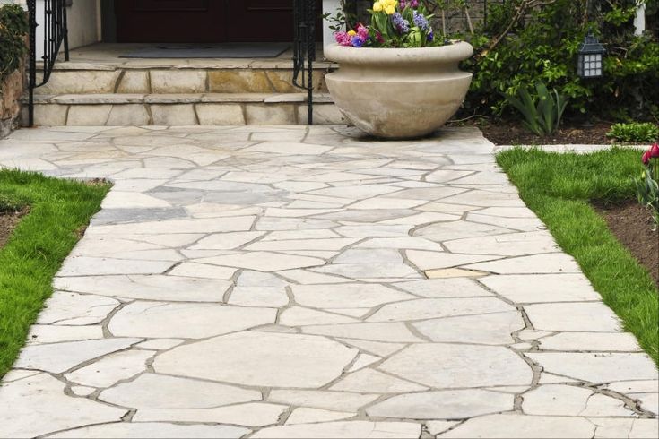 a stone walkway leading to a front door