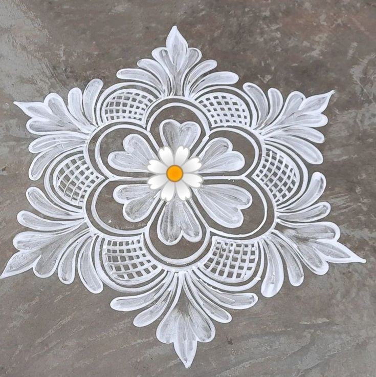 an intricately designed design on the ground in white and grey colors with yellow center