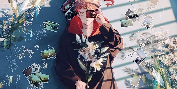 a man with red hair is holding a camera in front of flowers and pictures on the wall