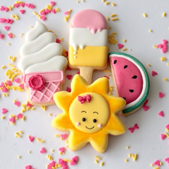 three decorated cookies sitting on top of a table