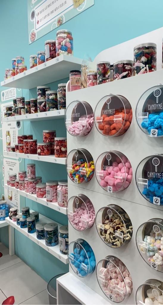 the shelves are filled with different types of candy