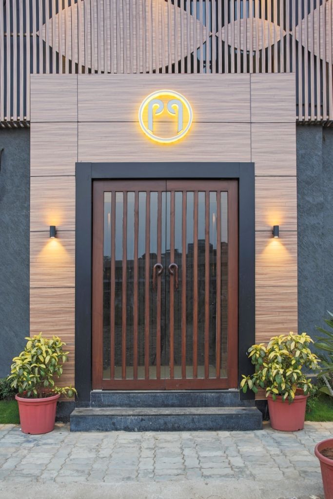 an entrance to a building with potted plants