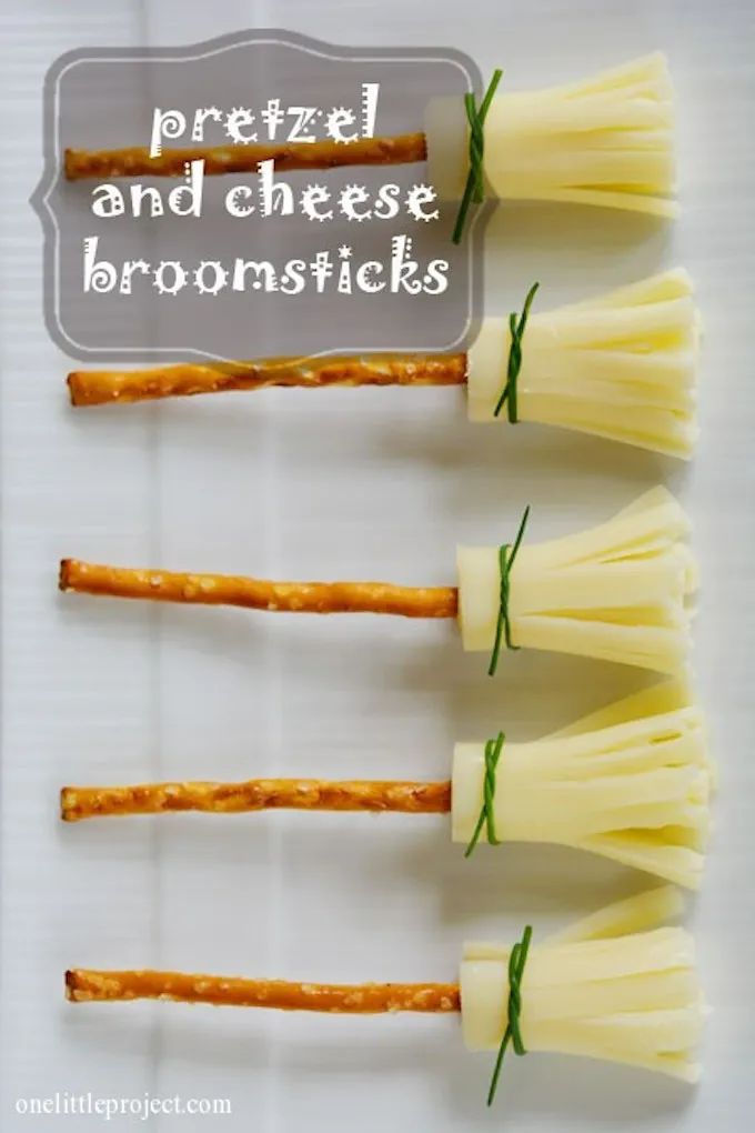 four pieces of cheese are arranged in the shape of toothpicks