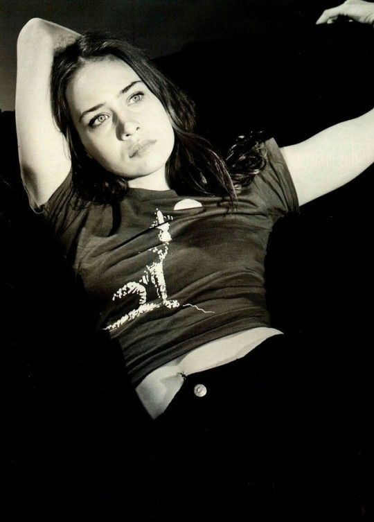 a black and white photo of a woman laying down