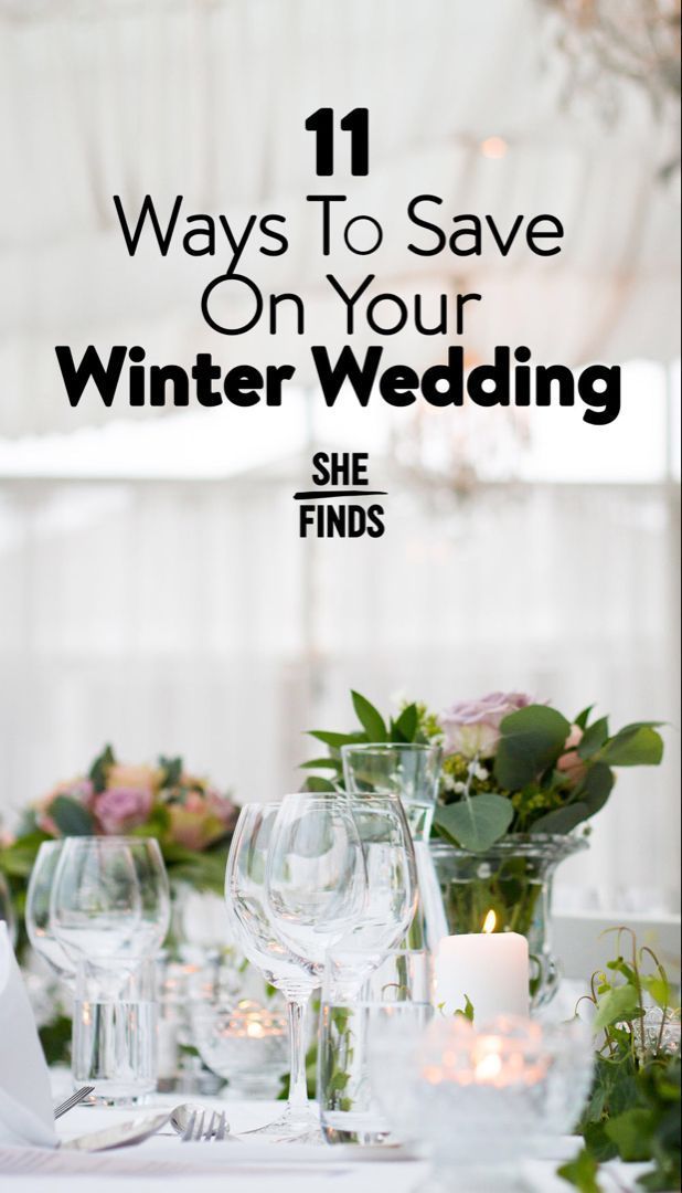 the table is set with wine glasses, candles and flowers on it for winter wedding