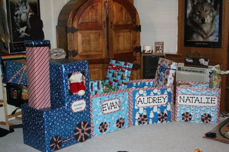 several presents are stacked on top of each other in front of a door and window