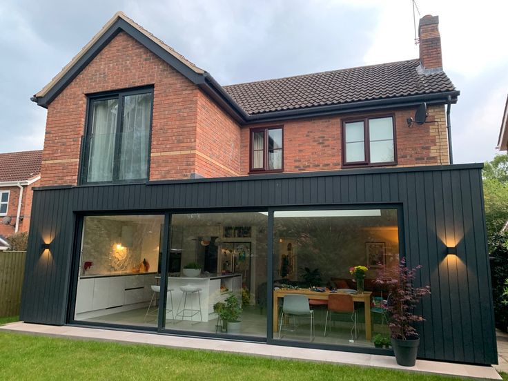 a modern house with large glass doors and windows