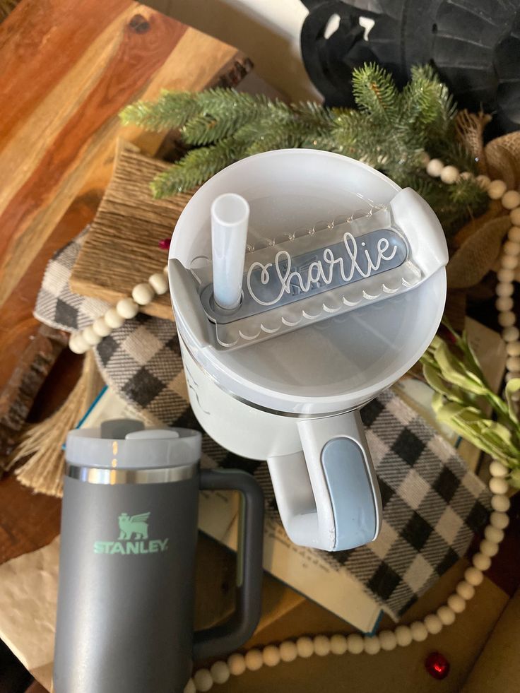 a close up of a blender on a table with christmas decorations and other items