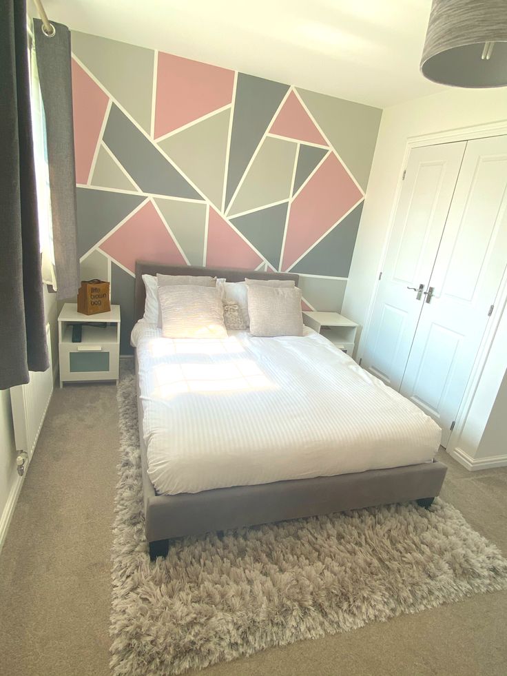 a bedroom with a bed, nightstands and rug