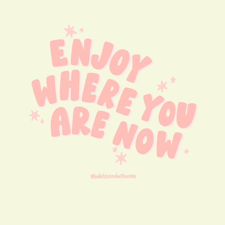 the words enjoy where you are now written in pink on a light green background with stars