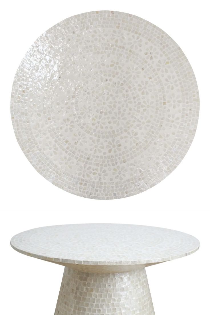 a white plate sitting on top of a table next to a round cake stand with a circular