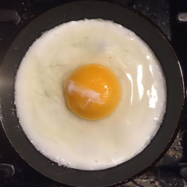 an egg in a frying pan on the stove