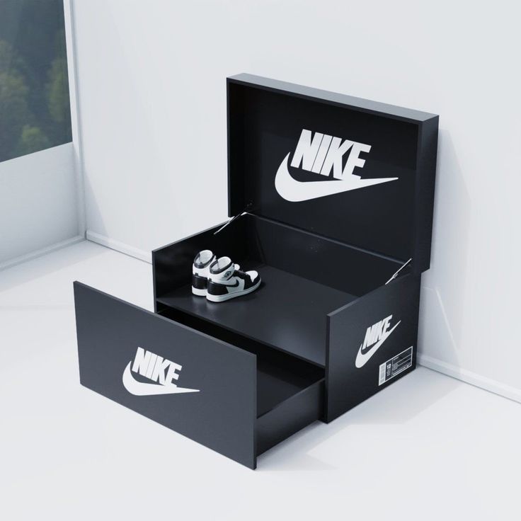 two black boxes with white nike logos on the side and one has a pair of shoes in it