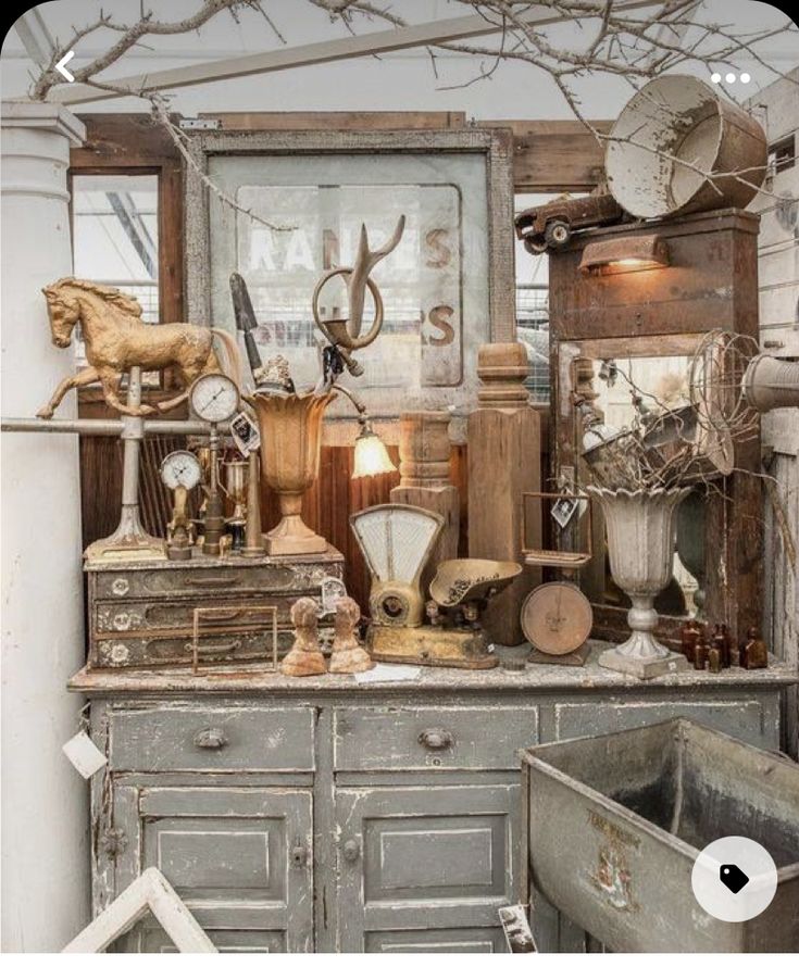 an old dresser with lots of antiques on it