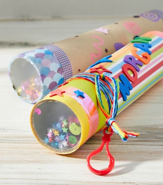 a roll of paper with the word happy written on it and some string attached to it