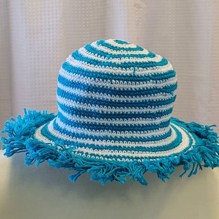 Our hats provide optimal coverage for a day at the beach or the pool. Try this fun look with silly fringe and stripes... a fun new twist on our most popular item! Variety of colors available. Hand crocheted, 100% cotton, washable Summer Beach Hat With Stripes, Striped Summer Hats For Vacation, Summer Striped Vacation Hat, Summer Vacation Striped Hat, Striped Brimmed Sun Hat For The Beach, Striped Brimmed Sun Hat For Beach, Striped Brimmed Sun Hat For Vacation, Adjustable Striped Brimmed Sun Hat, Light Blue Beach Hat One Size Fits Most