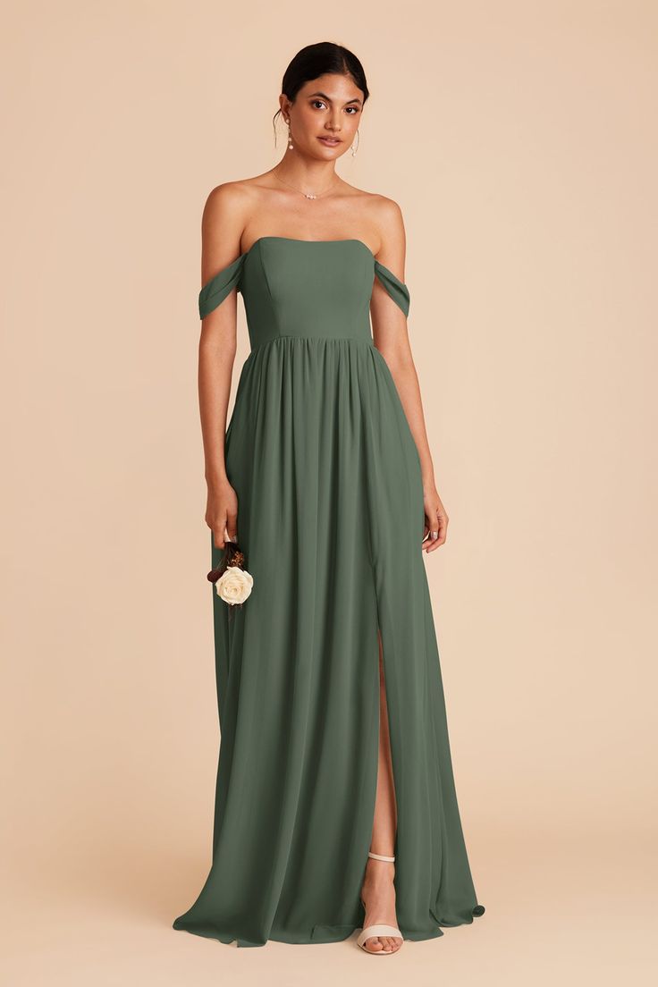 a woman wearing a green bridesmaid dress with an off the shoulder top and side slit