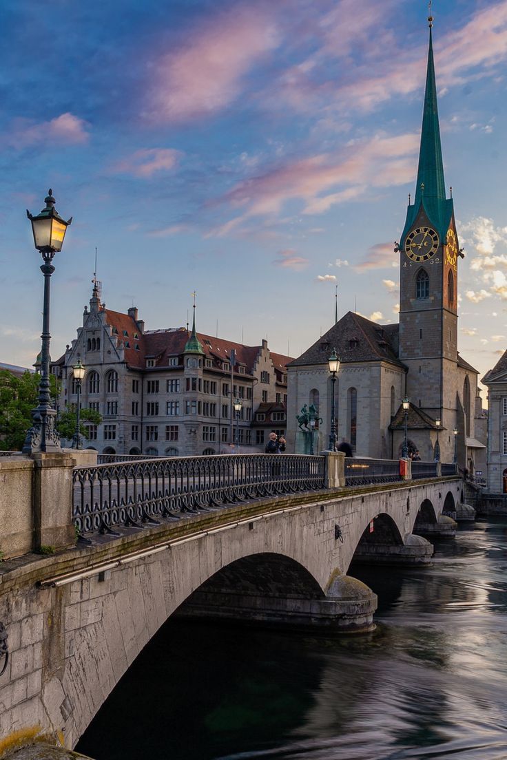 a bridge over a river with buildings in the background