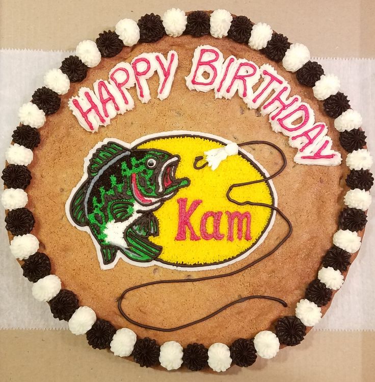 a birthday cake with a fish on it and the words happy birthday kam written in large letters