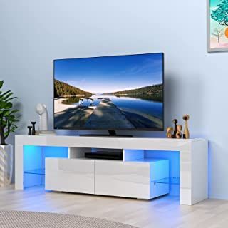 a flat screen tv sitting on top of a white entertainment center in a living room