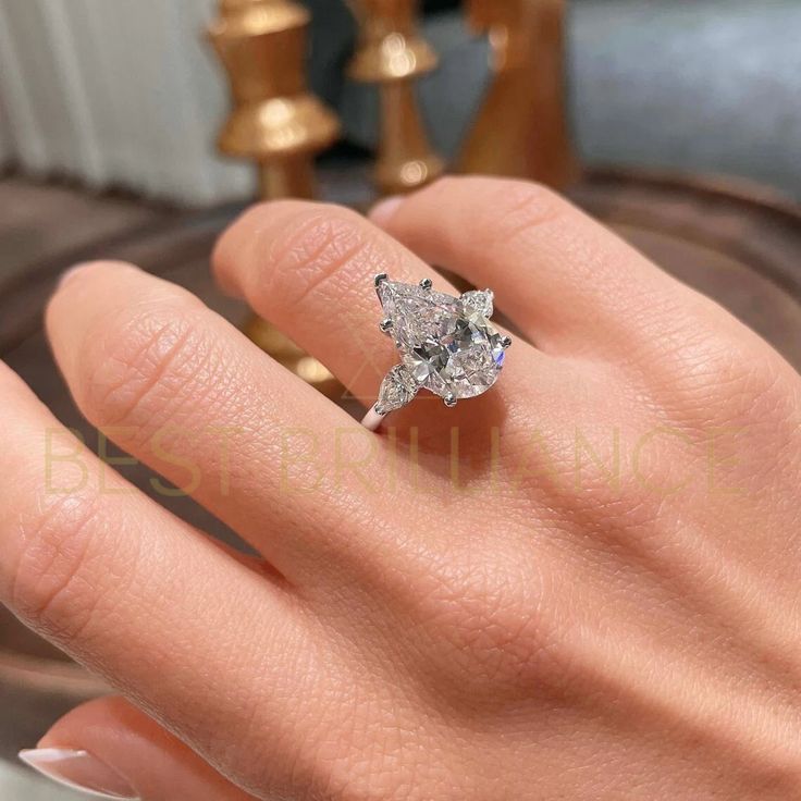 a woman's hand with a diamond ring on it