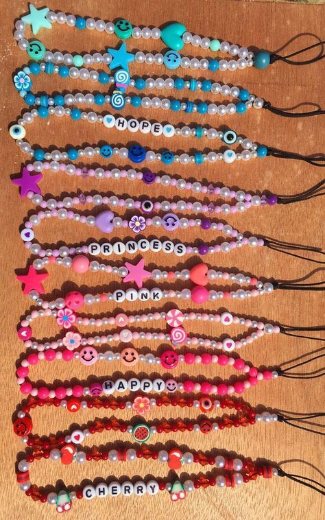 several bracelets with different designs and colors are arranged on a wooden surface, one is made out of plastic beads