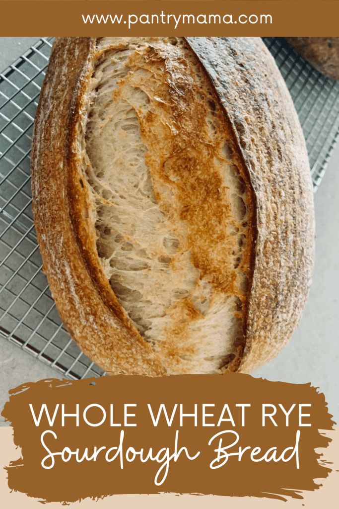 whole wheat rye sourdough bread on a cooling rack with text overlay that reads, whole wheat rye sourdough bread