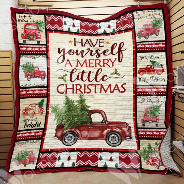 a red truck with a christmas tree on the back is sitting in front of a wall hanging