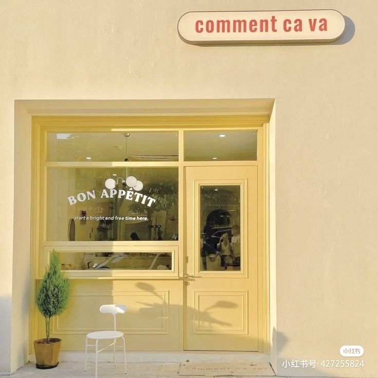 the front entrance to a restaurant called bon appetit with chairs and potted plants