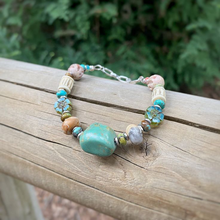 "This unique beaded bracelet will complete your bohemian look with it's eclectic array of beautiful stones and carved bone. It can also be personalized to make a memorable gift for any woman, from your favorite hiker or outdoor lover to your boho femme fatale.  The bracelet is handcrafted with both sterling silver and stainless steel components. It has an extender chain for wrist most sizes (6-7.5\"). This piece features carved bone, Turquoise, \"Crazy Lace\" Agate, Czech Glass, Carved Soapstone Bohemian Bracelet With Round Wooden Beads, Adjustable Turquoise Bracelets With Nature-inspired Style, Earthy Turquoise Bracelets For Festival, Rustic Wooden Beads Bracelet, Adjustable Hippie Bracelets With Natural Stones, Hippie Beaded Bracelets With Natural Stones For Festivals, Hippie Adjustable Bracelets With Natural Stones, Hippie Healing Bracelets With Round Beads, Hippie Turquoise Round Bead Bracelets