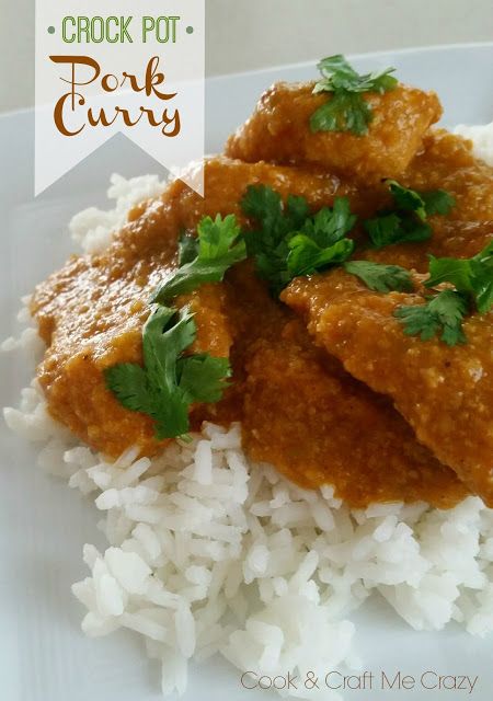 a white plate topped with rice and meat covered in gravy, garnished with cilantro