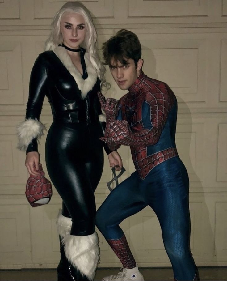 two people dressed as spiderman and catwoman