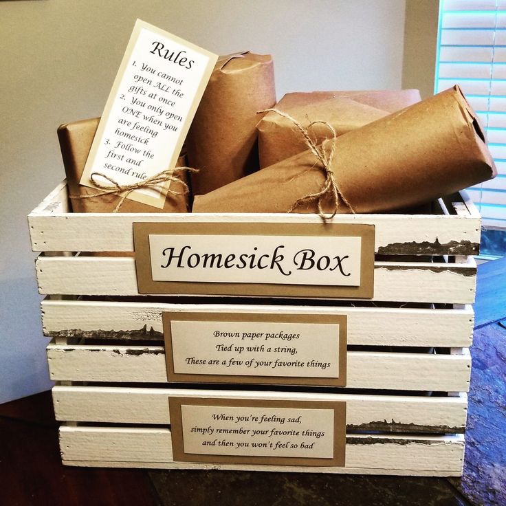 a wooden box filled with lots of boxes and wrapped in brown paper on top of a table