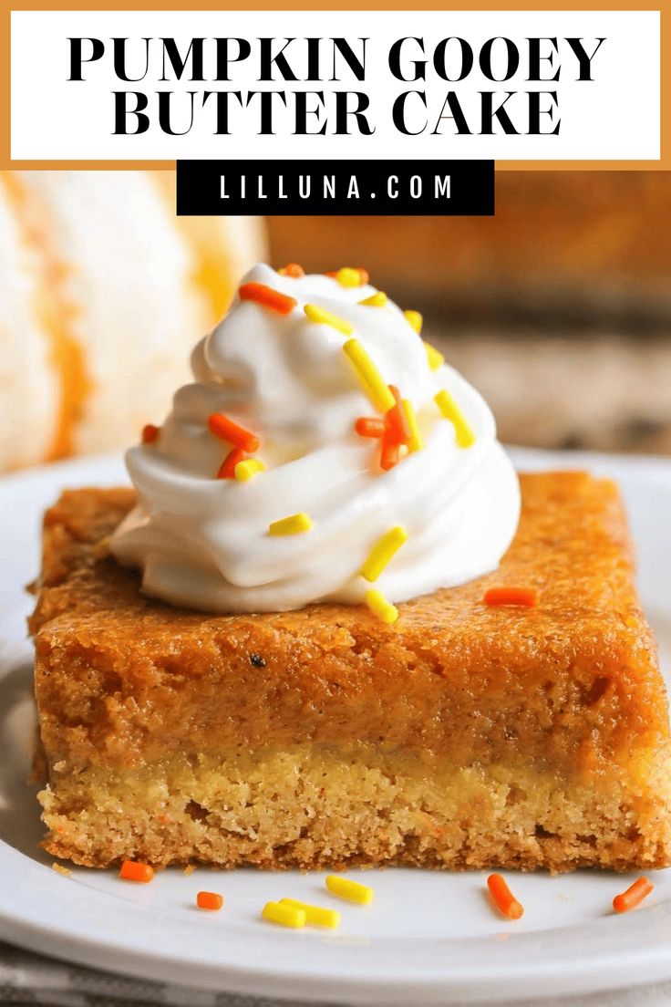 a slice of pumpkin gooey butter cake on a plate with whipped cream and sprinkles