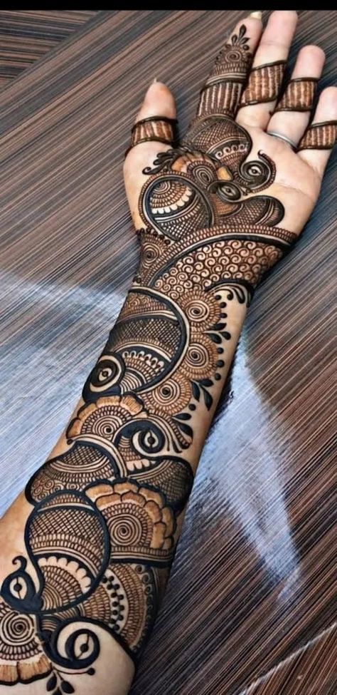 a woman's hand with hennap on it, and the design is intricately designed