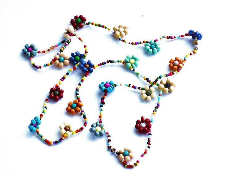 "Add colorful floral fun to your outfits with this charming necklace featuring hand-beaded flowers all along its generous 24\" length! Vibrant multicolored beads form little flowers and add delicate, yet eye-grabbing style as they dangle! And perhaps buy a couple chains at a discount to double the floral loveliness! And consider a coordinating ankle bracelet, pictured above to complete your set! Beaded Flower Necklace (elasticized cord), 24\" long, flowers 1/2\" diameter MANY ARTFUL ITEMS ARE AV Beaded Flower Necklace For Summer Gifts, Flower-shaped Colorful Beaded Necklaces For Summer, Colorful Flower-shaped Beaded Necklaces For Summer, Summer Flower-shaped Beaded Necklaces With Colorful Beads, Summer Flower Shaped Beaded Necklace With Tiny Beads, Summer Flower Necklace With Round Beads As Gift, Summer Flower-shaped Beaded Necklace With Tiny Beads, Summer Gift Flower Necklace With Round Beads, Adjustable Multicolor Flower Necklace For Spring