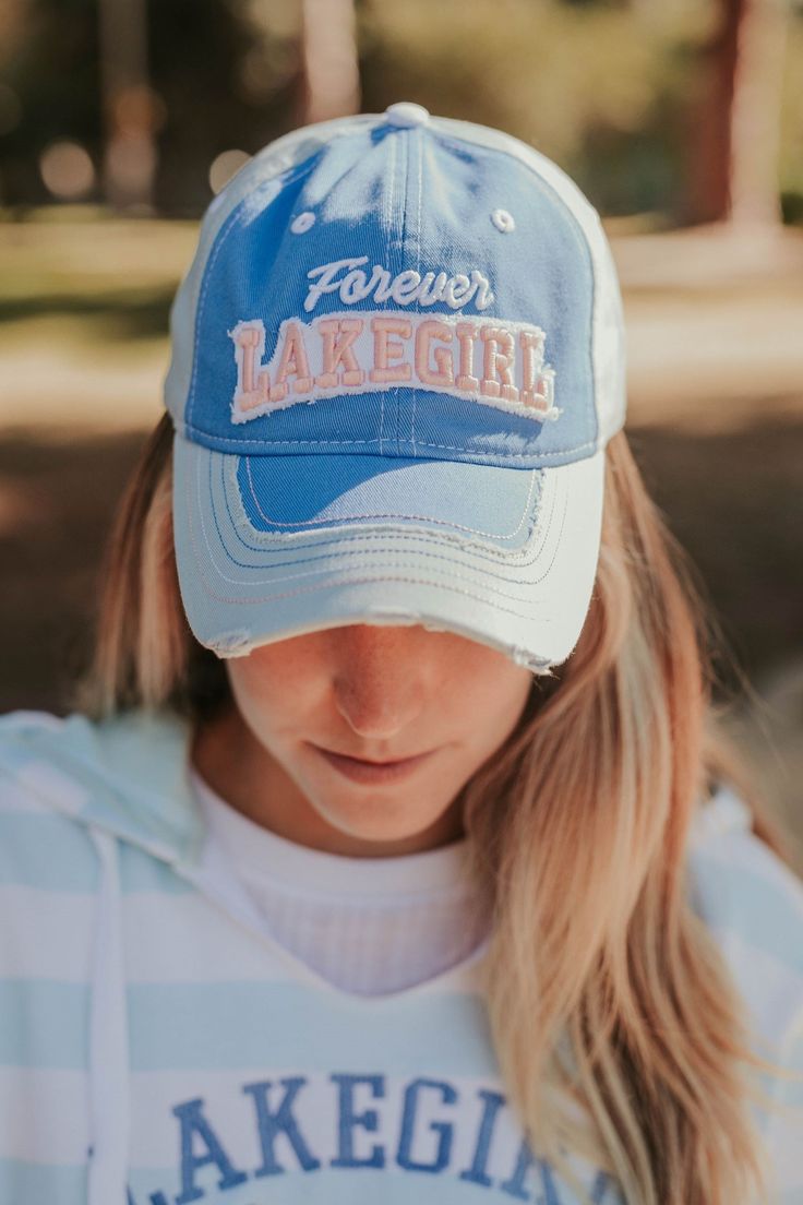 The ever-popular Jeannie Cap gives you more colors to coordinate with your wardrobe. Features distressed brim, 3D Forever Lakegirl design in contrasting embroidery across the front, polyester mesh back with adjustable Velcro closure. 100% cotton front, polyester mesh Spring Sports Mesh Trucker Hat, Spring Mesh Baseball Cap, Sporty Snapback Trucker Hat, Spring Mesh Trucker Hat, Trendy Cotton Trucker Hat For Sports, Spring Mesh Snapback Hat With Curved Bill, Spring Sports Trucker Hat With Curved Bill, Adjustable Mesh Hats For Spring, White Mesh Snapback Hat For Spring