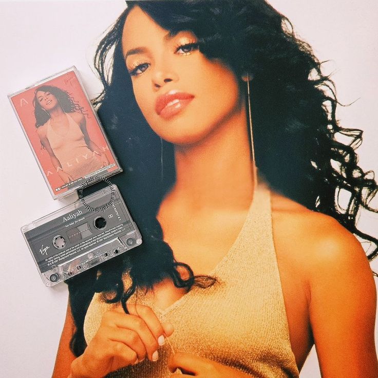 a woman with long hair holding an old cassette