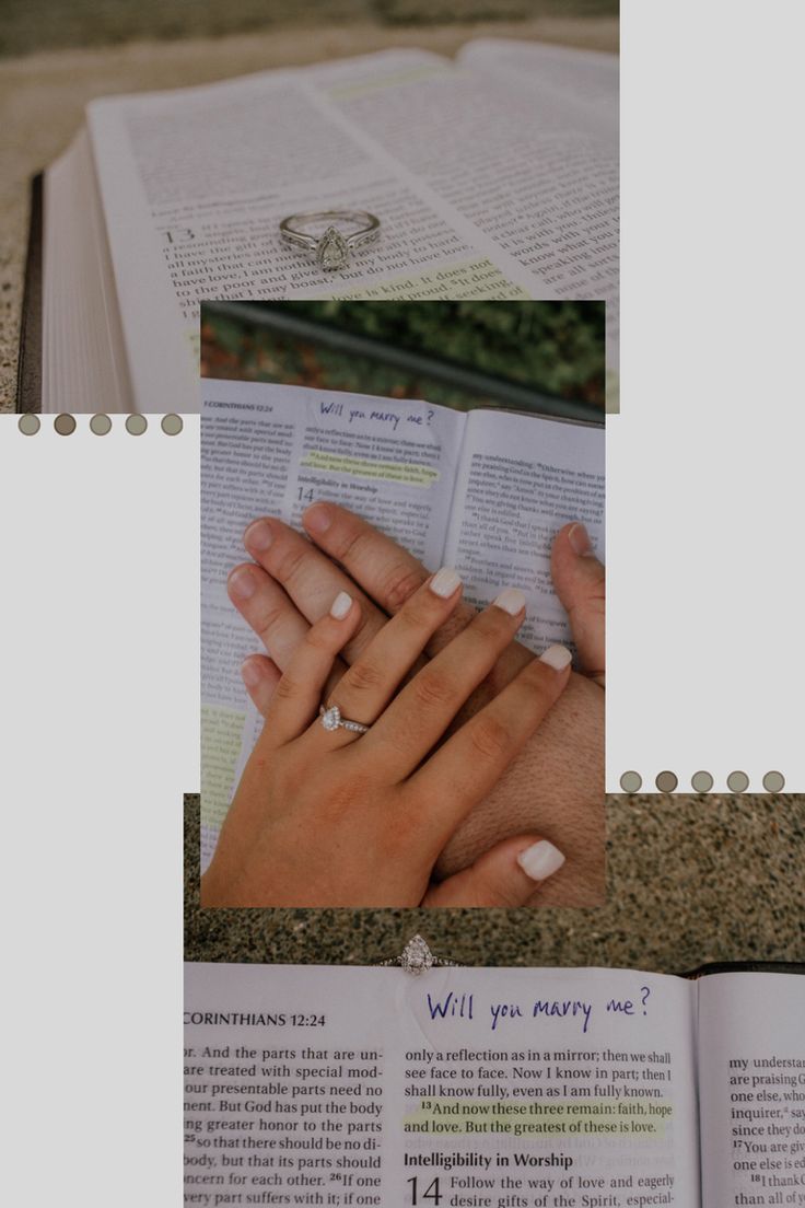 two hands are touching each other while holding an open book with wedding rings on it