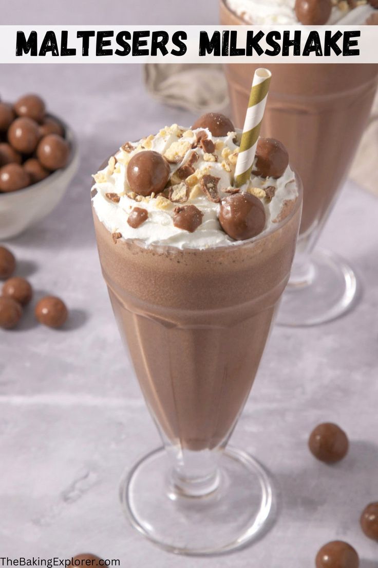 two glasses filled with chocolate milkshake and topped with marshmallows